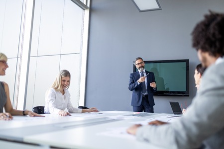 Business colleagues working in modern conference roomの写真素材
