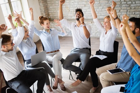 Business, startup, gesture, people and teamwork concept - happy creative team in office