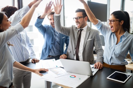 Business team celebrating a good job in the office