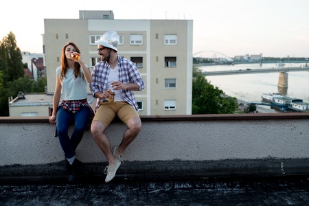 Couple in love enjoying in sunset in a terraceの写真素材