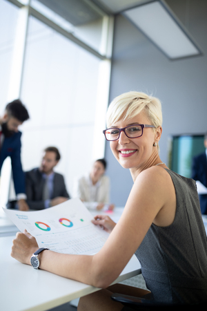 Businesspeople discussing together in conference room during meeting at officeの写真素材