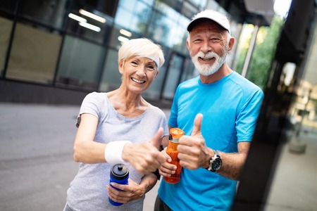 Beautiful mature couple jogging in nature living healthyの写真素材