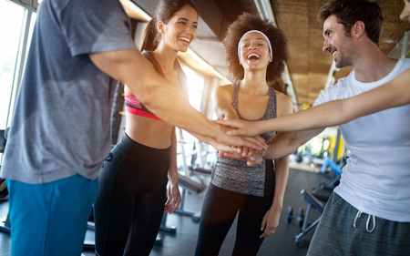 Group of young people doing exercises in gymの写真素材