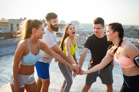 Fitness, sport, friendship and healthy lifestyle concept . Group of happy people exercisingの写真素材