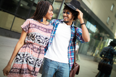 Couple of tourists taking a walk in a city street sidewalk in a sunny dayの写真素材