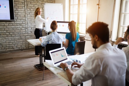 Business, technology and people concept - creative team or designers working in office