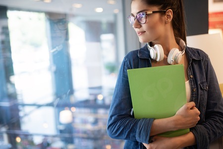 Portrait of young beautiful smiling woman working or studyingの写真素材