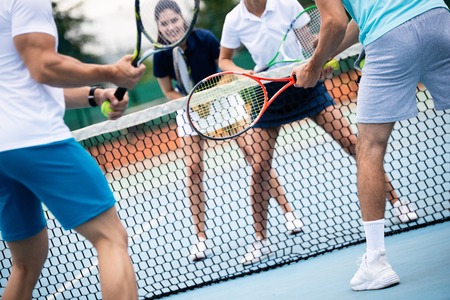 Fit happy poeple playing tennis together. Sport conceptの写真素材