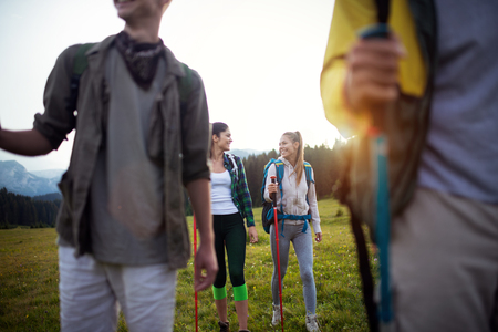 Group of young friends hiking in countryside. Multiracial young people on country walk.の写真素材