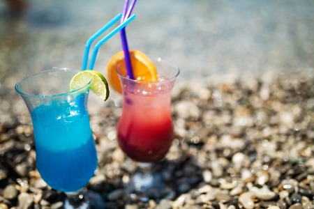 Two tropical fresh juices, cocktails on beachの写真素材