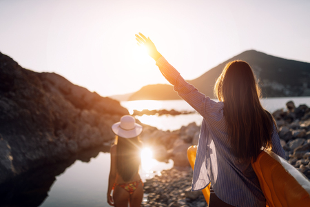 Beautiful friends women enjoying walking on beach on vacationの写真素材