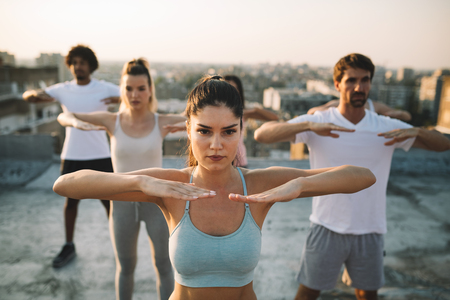 Fitness, sport, friendship and healthy lifestyle concept - group of happy sporty friendsの写真素材