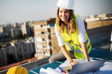 Portrait of engineer, architect young woman working on construction siteの写真素材