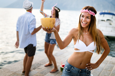 Group of friends having fun and dancing on the beach. Summer party on the beachの写真素材