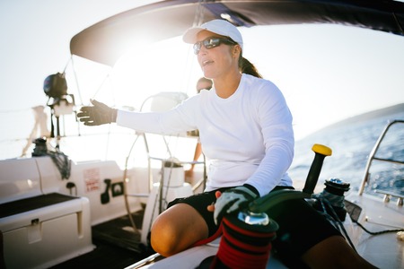 Attractive strong woman sailing with her boatの写真素材