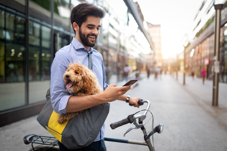Lifestyle, transport, communication and people concept . Young man with bicycle and smartphone on city streetの写真素材