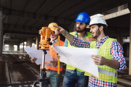 Construction engineers discussion with architects at construction or building siteの写真素材