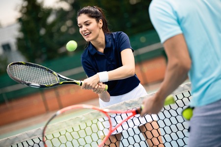 Fit happy poeple playing tennis together. Sport conceptの写真素材