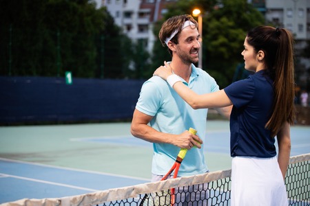 Group of healthy happy friends at the club playing tennisの写真素材