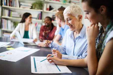 Cheerful coworkers in office during company meetingの写真素材