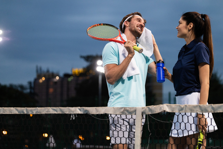 Group of healthy happy friends at the club playing tennisの写真素材