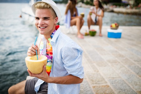 Group of friends having fun and dancing on the beach. Summer party on the beachの写真素材