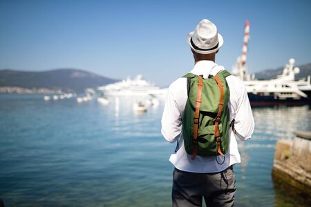 Vacation, holidays, travel, sea and people concept. Man with backpack enjoying travellingの写真素材