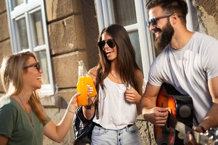Group of friends hanging out, having fun and enjoying summer days