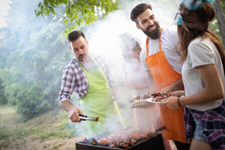 Group of friends having a barbecue party in natureの写真素材
