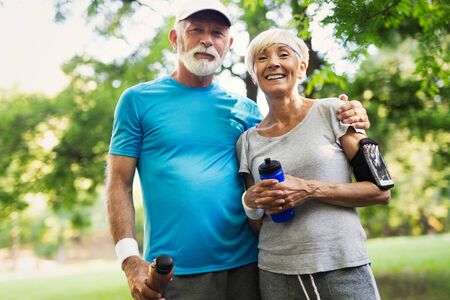 Senior couple jogging and running outdoors in natureの写真素材