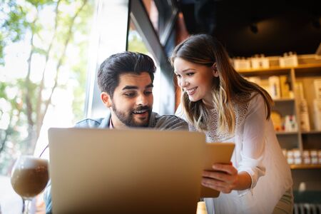 Portrait of a cheerful couple shopping online with laptopの写真素材