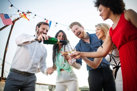 Group of happy friends drinking champagne and celebrating New Year