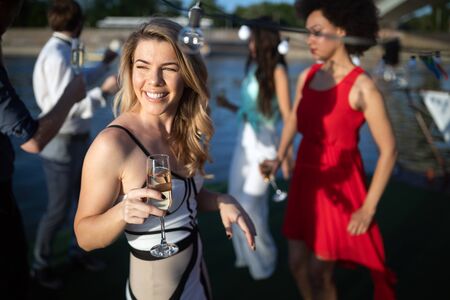 Group of happy friends drinking champagne and celebrating New Yearの写真素材