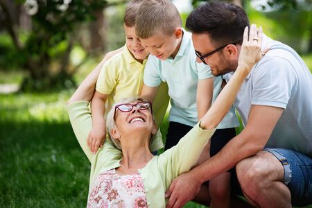 Happy family playing and enjoying picnic with children outsideの写真素材