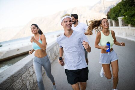 Group of young people jogging and running outdoors in natureの写真素材
