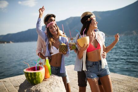 Summer, vacation, party, people concept. Group of friends having fun and party on the beach.の写真素材