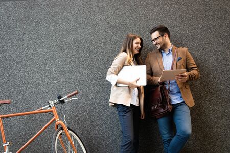 Office woman with business man couple enjoying break while talking flirting outdoor