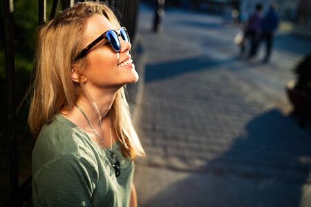 Happy woman having fun on city street during summer. Happiness concept