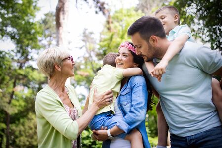 Happy family playing and enjoying picnic with children outsideの写真素材