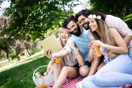 Group of young people taking a selfie outdoors, having funの写真素材