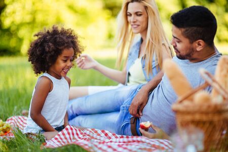 Picture of lovely couple with their daughter having picnicの写真素材