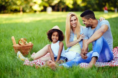 Picture of lovely couple with their daughter having picnicの写真素材