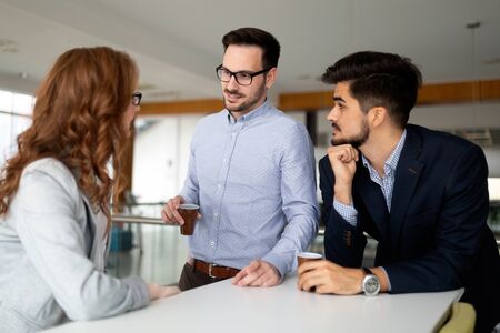 Business people chatting and drinking coffee at a conference iの写真素材