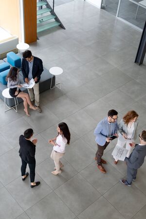 Business people working together in office hall.の写真素材