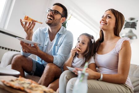 Portrait of happy family sharing pizza at homeの写真素材