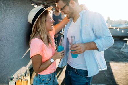 Happy young dancing couple having fun and enjoying party at summerの写真素材