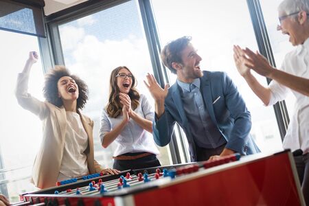 Happy business people celebrating success at company.の写真素材