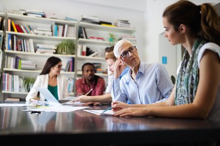 Cheerful coworkers in office during company meetingの写真素材