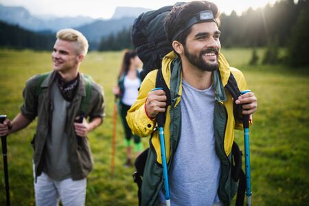 Group of hikers walking on a mountain and smilingの写真素材