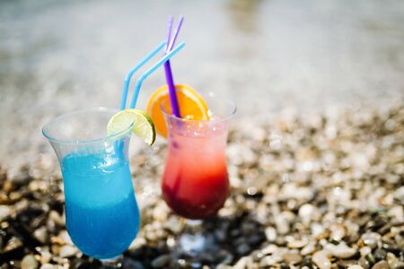 Two tropical fresh juices, cocktails on beachの写真素材